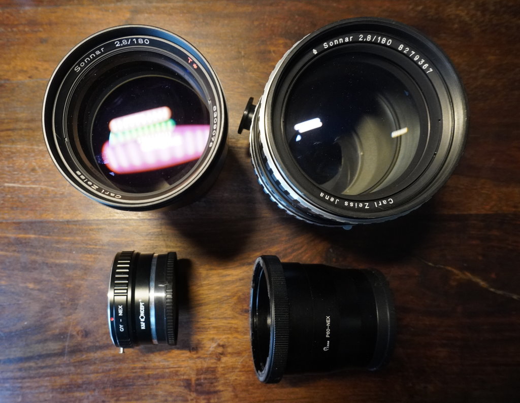 The full frame Carl Zeiss Sonnar T* 180mm f2.8 lens with Contax/Yashica mount made in West Germany (left) and medium frame the Carl Zeiss Jena Sonnar 180mm f2.8 lens with Praktisix P6 mount made in the German Democratic Republic (East Germany) 